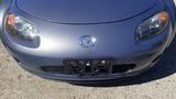 A silver 2007 Mazda Miata with rounded headlights and a prominent front grille featuring the Mazda emblem