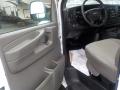 Interior view of a 2011 Chevrolet Express showcasing the driver's side door with controls and a fabric-covered seat