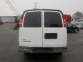 A white 2011 Chevrolet Express van viewed from the rear with tinted windows and red taillights