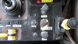 Control panel of a 2003 International 5600i with levers and switches for various functions including tarp and pump controls