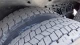 Close-up view of two large truck tires with deep treads designed for heavy-duty performance on an International 5600i model