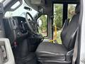 Interior view of a 2018 Chevrolet Express showing the driver's seat steering wheel and dashboard with controls