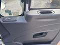 Interior door panel of a 2012 International DuraStar 4300 featuring controls for window operation and a hand grip for ease of entry