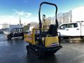 A yellow 2013 Yanmar C12R-B compact track dumper with a protective roll cage and an open dump bed is parked on a wet surface