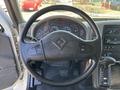 The interior view of a 2011 International 4300 showing the steering wheel dashboard with gauges and controls as well as the gear shift lever