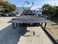 A 2018 Ford F-750 truck viewed from behind with a flatbed and textured surface ready for hauling or transporting goods
