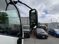 A 2018 Hino 195 medium-duty truck with a side mirror view displaying other vehicles in the background