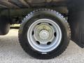 A close-up of a 2018 Hino 195 truck tire showcasing a silver metal rim and a rugged black tread design