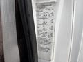 Close-up of a 2014 Ford E-350 vehicle specifications label showing details about weight ratings and tire information