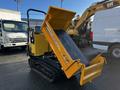 A yellow 2013 Yanmar C12R-B compact truck with a tracked base and a hydraulic dump bed raised at an angle