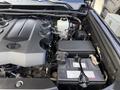 Engine compartment of a 2021 Toyota 4Runner featuring a large engine cover and visible components including a battery and coolant reservoir