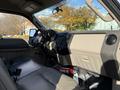 Interior view of a 2008 Ford F-550 showing the dashboard and beige upholstery with controls and gear shifter visible