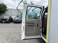 The image shows the open driver side door of a 2010 Ford F-550 Super Duty with a beige interior panel and handle