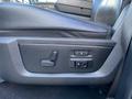 The seat adjustment controls are shown in the foreground of a 2017 RAM 1500 interior with a black textured finish