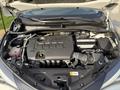A 2021 Toyota C-HR engine with various components including hoses and a battery visible under the hood