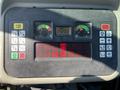 Control panel of a 2015 Bobcat 5600 showing gauges for temperature and fuel along with various buttons and indicators