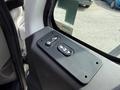 Close-up of the control panel in a 2011 International 4300 featuring buttons for automatic windows and door locking