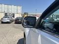 A white 2017 Chevrolet Colorado with a side mirror prominently visible in the foreground