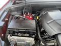 Close-up view of the engine compartment of a 2015 Jeep Grand Cherokee showing the engine components and battery