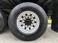 Close-up of a 2019 Ford F-750 tire featuring a silver wheel rim with multiple bolts and a black rubber tire with the label Continental on the side