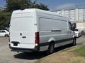 A 2019 Mercedes-Benz Sprinter van in white with a high roof and large rear doors parked at an angle with black trim around the windows and wheels