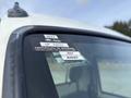 A close-up of a 2010 Daihatsu Hijet window displaying a certificate of approval sticker with details for the months of July and August