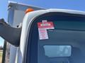 2022 Isuzu NRR with a red certificate of approval sticker on the driver's side window displaying months of the year