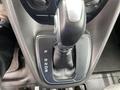 Close-up of the gear shifter of a 2017 Ford Transit Connect showing the drive modes P R N D and a leather boot