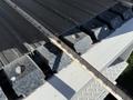 A 2011 Freightliner M2 106 with a measuring tape placed on a flat surface showing the length of blocks used in the vehicle's construction