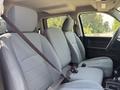 Interior of a 2013 RAM 2500 showing two front seats with grey upholstery and seatbelts fastened