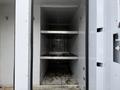 Interior view of a 2015 Freightliner M2 with two metal shelves and a dirty floor showing the empty cargo space