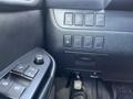Close-up of the control panel in a 2018 Toyota Highlander featuring window controls and various buttons for vehicle functions