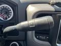 Close-up of the gear shift lever in a 2015 RAM 1500 with an indicator on the side and a textured grip