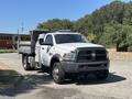 A 2016 RAM 5500 truck with a flatbed and tool compartment parked on a road