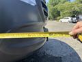 A 2019 Mercedes-Benz Sprinter with a measuring tape extended across the front bumper measuring its dimensions