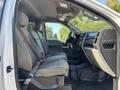 Interior view of a 2019 Ford F-550 showing the front seats and dashboard with a spacious cabin and a simple, functional design