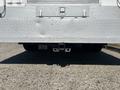 Rear view of a 2011 Ford F-550 showing the hitch and metal diamond plate surface with visible wear on the lower part of the vehicle