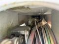 A close-up view inside a compartment of a 2008 International 7500 showing various wires and cables tangled together