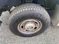 Close-up of a tire on a 2014 Ford F-350 SD featuring a Bridgestone brand tire with visible tread pattern and a steel rim
