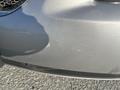 Close-up of a silver 2006 Pontiac G6 showing scratches and minor scuffs on the front bumper