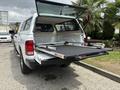 A 2013 RAM 1500 with an open truck bed featuring a sliding bed tray and a cap cover