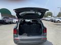 A 2022 Kia Sorento with its rear hatch open revealing a spacious cargo area with folded rear seats