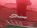 Close-up of a red 1970 Chevrolet Corvette with the "Stingray" badge prominently displayed on the side