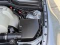 Close-up of the engine bay of a 2004 BMW 6-Series showcasing the engine components and a black air intake box