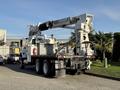 A 2011 International 7500 truck equipped with an elevated crane and work platform mounted on the bed, designed for utility or construction use