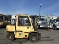 A yellow 1993 Hyster H80XL forklift with a raised fork and a single mast visible on the front