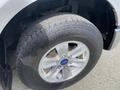 A close-up of a tire on a 2015 Ford F-150 showing the Hankook brand and the chrome wheel rim