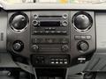 Interior dashboard of a 2015 Ford F-350 SD featuring audio controls climate settings and various electronic buttons