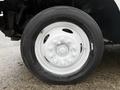 A close-up of a white wheel and tire on a 2018 Ford E-450 with visible tread and lug nuts