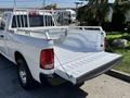 White 2019 RAM 1500 Classic pickup truck with an open bed and a metal storage rack on the back